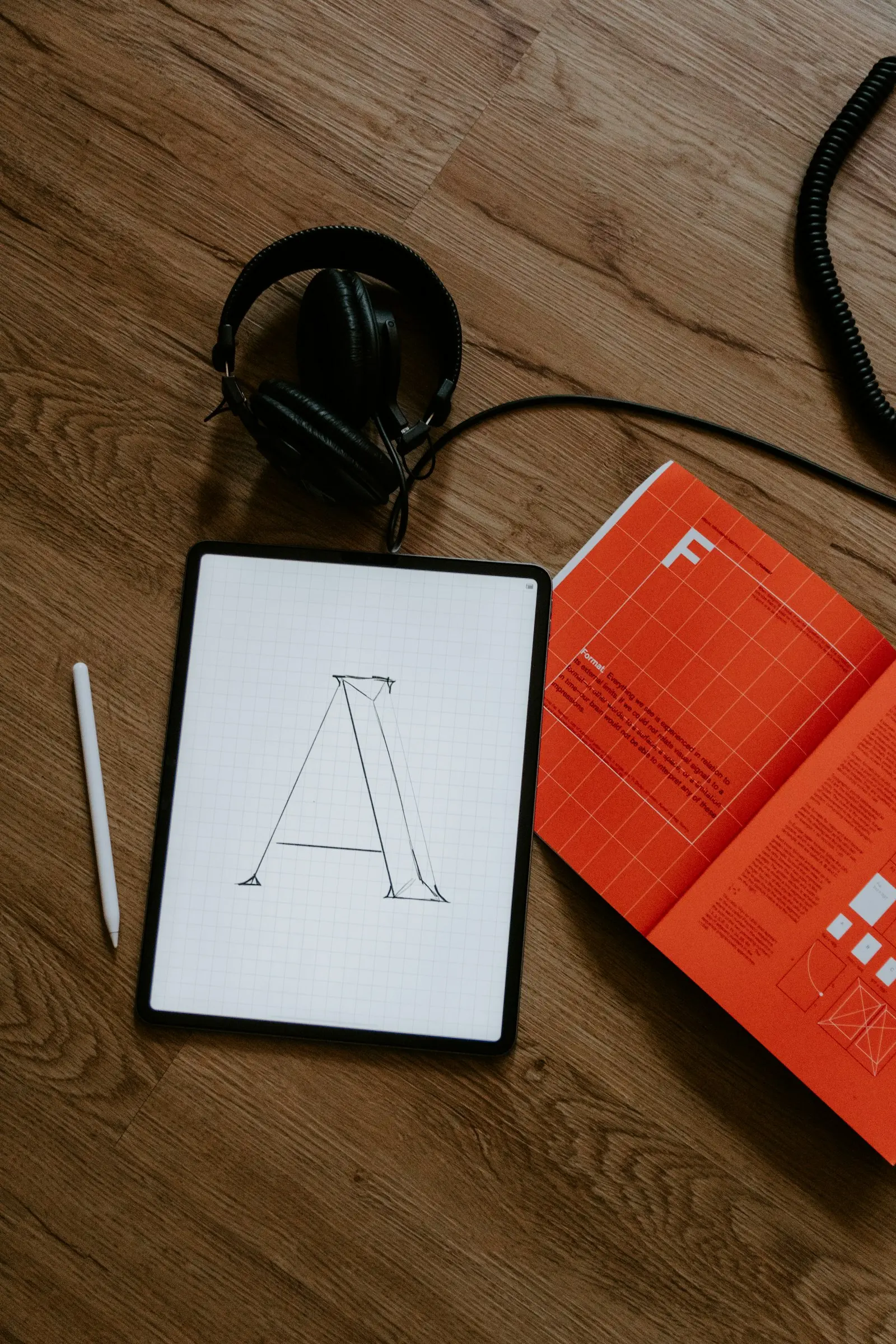 Hand-lettered logo concept on a tablet